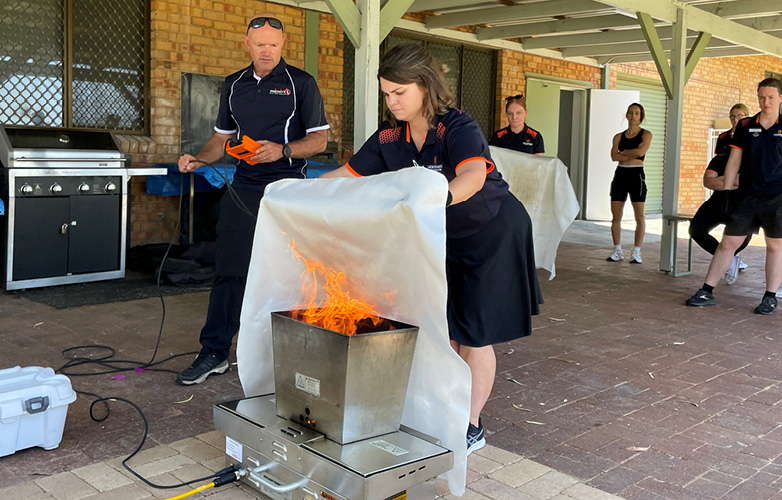 LLC staff using fire blankets